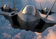 Up close photo of 3 F-35 fighter jets flying in close formation.