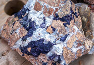 A high-grade rare earths sample with blue and white crystals.