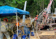 A crew of three operates a reverse circulation drill testing for gold in Alaska.