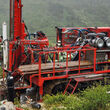 Drill crew operating a bright red rig at BMC’s Kudz Ze Kayah project.