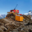 A drill rig tests for gold and silver atop a mountain ridge in Northern BC.