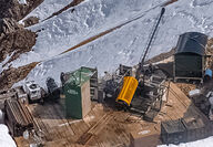 Aerial view of drill testing for gold in a mountainous area of Alaska.