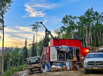 A drill tests for gold during a near midnight sunset north of Fairbanks, Alaska.