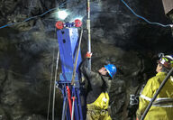 As one worker looks on, another completes underground drilling at Snip.