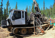 Mobile drill rig mounted on caterpillar tracks for easier drilling.