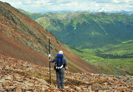 Geologist surveying on a slope overseeing the Rogue property in Yukon.