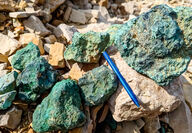 A rind of green malachite (copper carbonate) covers rocks collected at Storm.