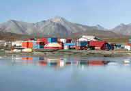 The Red Dog Mine processing facilities reflect off the water on a summer day.