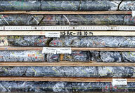 A box of drill core with abundant quartz veining and silver mineralization.