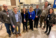 Group photo in front of a partially assembled Westinghouse eVinci microreactor.