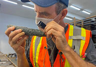 Grande Portage geologist examining core with a lathe.