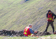 Exploration crew examining a mineralized outcropping at Mt. Hinton project.