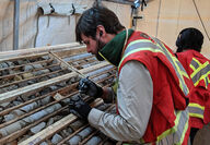 Geologist examines core from drilling at the Lawyers gold-silver project.