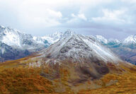 A blanket of snow covers Alaska Range mountains during the fall.