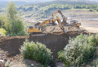 Heavy equipment constructing a containment berm.