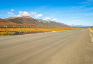 Dirt highway and oil pipeline from Alaska's North Slope.