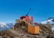 A drill tests for gold from atop a mountain ridge in Northern British Columbia.