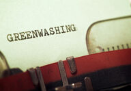 A stylized adobestock picture of the word greenwashing on paper in a typewriter.