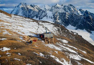 drill test for copper and gold and a partially snow-covered mountain slope.