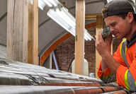 Geologist uses loupe to examine drill core from gold exploration at Yellowknife.