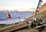 Helicopter approaches a drill testing the mineral-rich Arctic deposit in Alaska.