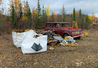 A pile of various junk and debris left in the Yukon wilderness from the 1980s.