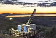 A colorful sunset backdrops a drill at the Graphite Creek project in Alaska.