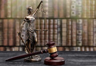 An adobe stock image of a statuette of Lady Justice beside a gavel.